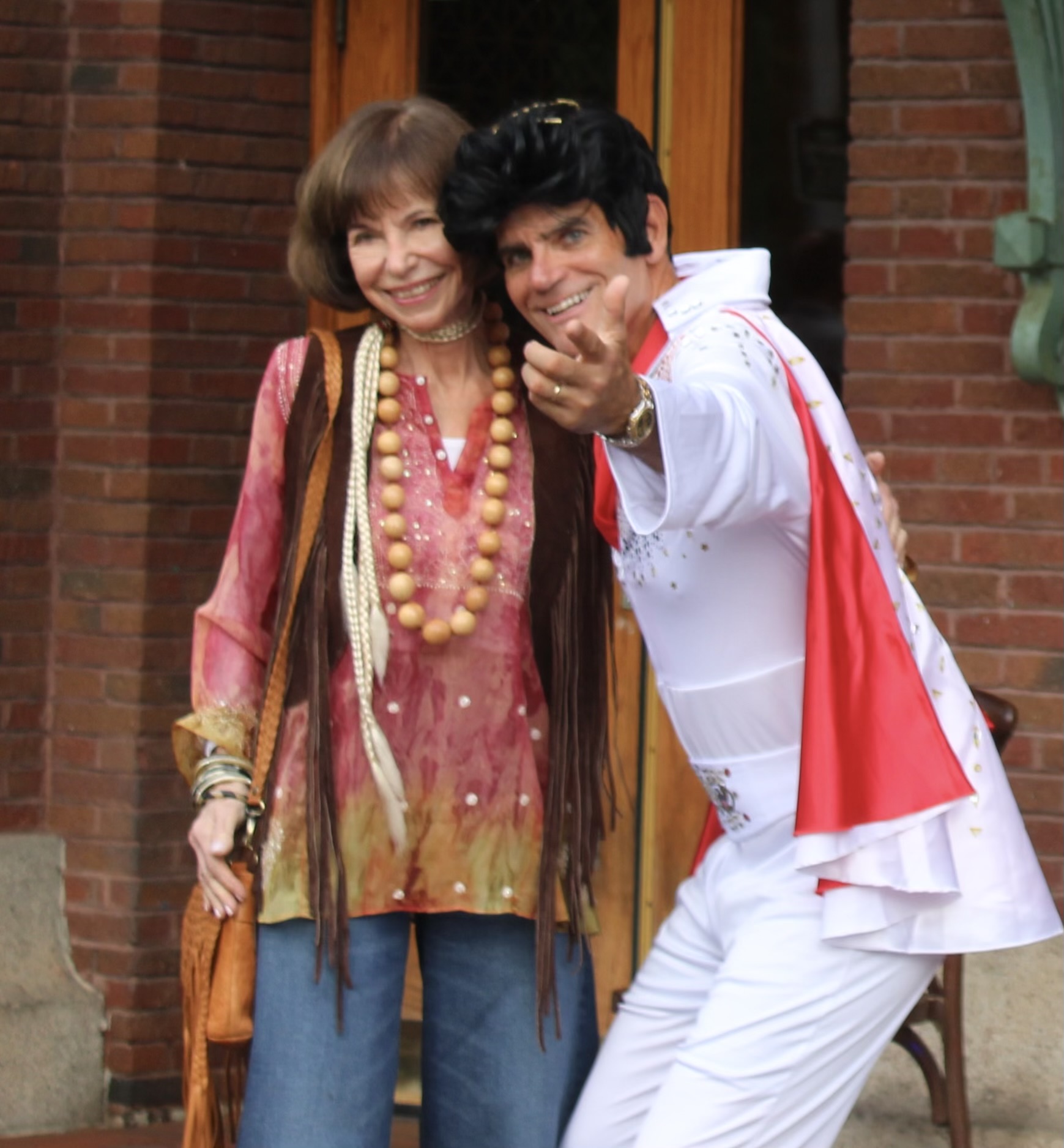 Elvis (Village member Bill Wright) greets a guest decked out in tie-dye, beads, and bell-bottoms.